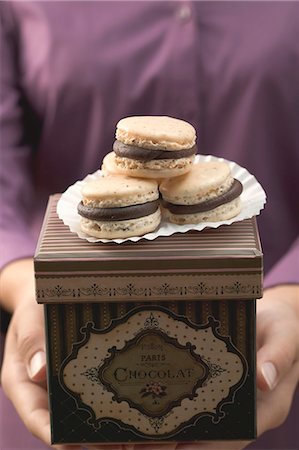 Woman holding macarons (small French cakes) on box Stock Photo - Premium Royalty-Free, Code: 659-03525100