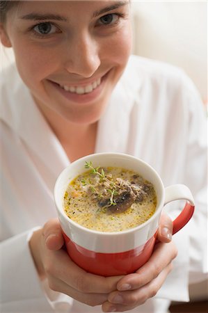 simsearch:659-02212898,k - Young woman holding cup of mushroom sauce Stock Photo - Premium Royalty-Free, Code: 659-03525114