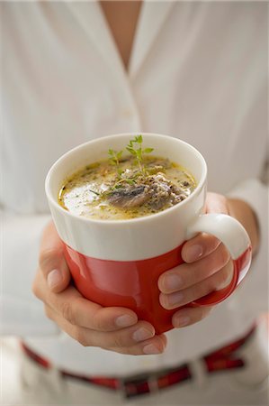 simsearch:659-02212898,k - Young woman holding cup of mushroom sauce Stock Photo - Premium Royalty-Free, Code: 659-03525116