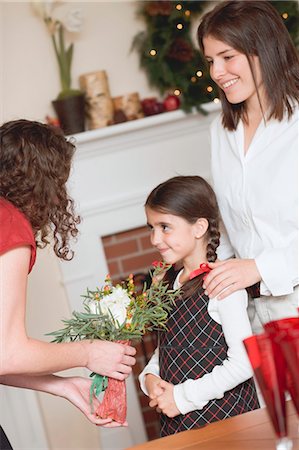 Two women and small girl in front of fireplace (Christmas) Stock Photo - Premium Royalty-Free, Code: 659-03525126