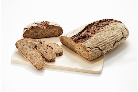 rye - Two different loaves of wood-oven bread, partly sliced Stock Photo - Premium Royalty-Free, Code: 659-03525146