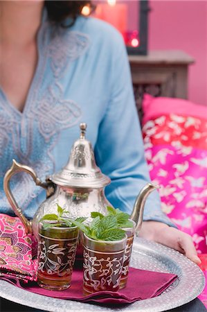 Woman serving peppermint tea on tray Stock Photo - Premium Royalty-Free, Code: 659-03525321