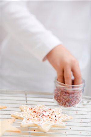 simsearch:659-07069854,k - Child decorating Christmas biscuit with sprinkles Stock Photo - Premium Royalty-Free, Code: 659-03525435