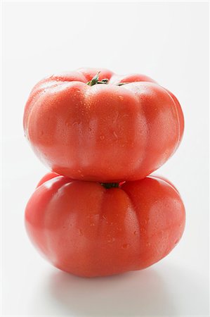 simsearch:659-03536260,k - Two beefsteak tomatoes, one on top of the other Stock Photo - Premium Royalty-Free, Code: 659-03525726
