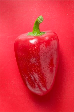 red bell pepper above - Red pepper with drops of water on red background Stock Photo - Premium Royalty-Free, Code: 659-03525722