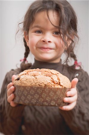 Small girl holding Christmas cake Stock Photo - Premium Royalty-Free, Code: 659-03525802