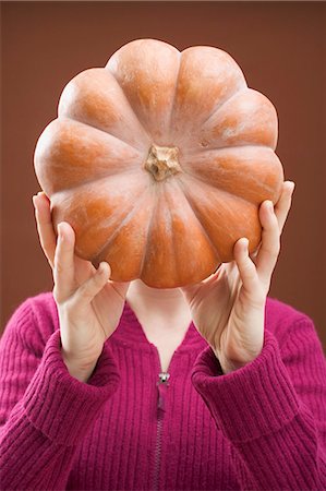 Woman holding pumpkin Stock Photo - Premium Royalty-Free, Code: 659-03526304