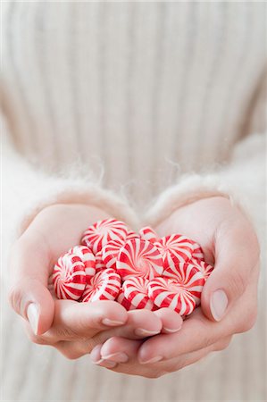 peppermint sweet - Hands holding red and white striped peppermints Stock Photo - Premium Royalty-Free, Code: 659-03526479