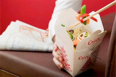 food delivery women - Hand holding Asian vegetable dish in take-away container Stock Photo - Premium Royalty-Free, Code: 659-03526521