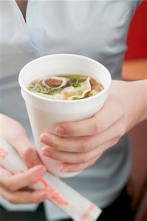 fast food soup - Woman holding paper cup of Asian noodle soup Stock Photo - Premium Royalty-Free, Code: 659-03526522