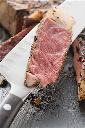 steak knife - Slice of spicy rib eye steak on knife (close-up) Stock Photo - Premium Royalty-Free, Code: 659-03526595