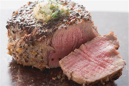 fillet steak - Peppered steak with herb butter, a slice cut off Stock Photo - Premium Royalty-Free, Code: 659-03526598