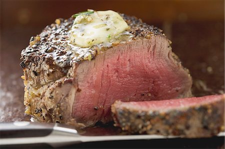 fillet steak - Peppered steak with herb butter, a slice cut off Stock Photo - Premium Royalty-Free, Code: 659-03526603