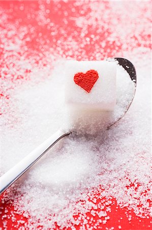 sugar cube on white - Sugar cube with red heart on spoon Stock Photo - Premium Royalty-Free, Code: 659-03526615