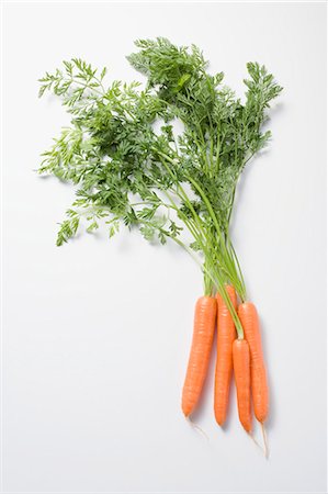 Fresh carrots with tops Fotografie stock - Premium Royalty-Free, Codice: 659-03526740