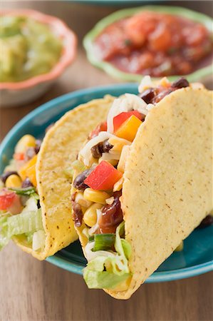 pulse and cereal dish images - Vegetable tacos, dips in background (Mexico) Stock Photo - Premium Royalty-Free, Code: 659-03526919