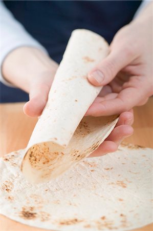 Rolling a tortilla Stock Photo - Premium Royalty-Free, Code: 659-03527106