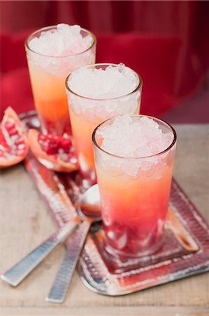 simsearch:659-02213271,k - Three fruity drinks with orange juice & pomegranate Foto de stock - Royalty Free Premium, Número: 659-03527196