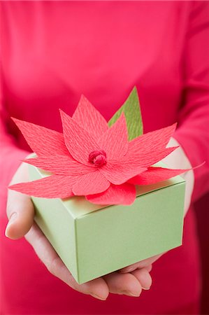 Woman holding Christmas parcel with poinsettia Stock Photo - Premium Royalty-Free, Code: 659-03527241