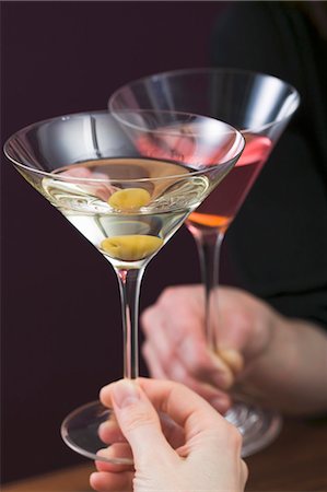 simsearch:659-03529606,k - Hands clinking glass of Martini & glass of Cosmopolitan Stock Photo - Premium Royalty-Free, Code: 659-03527290
