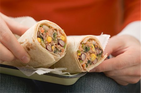 simsearch:659-01858654,k - Woman holding bean burritos Stock Photo - Premium Royalty-Free, Code: 659-03527303