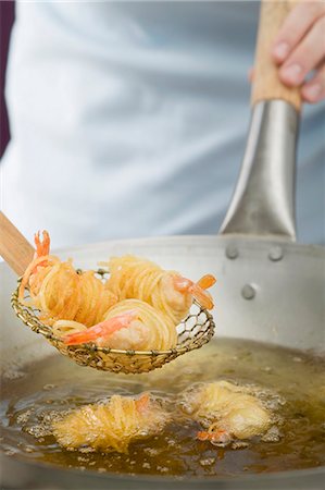 fried seafood - Deep-frying noodle-wrapped prawns in wok Stock Photo - Premium Royalty-Free, Code: 659-03527322