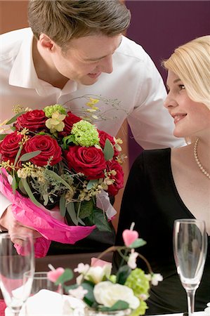 double gifts - Man giving woman a bouquet of flowers Stock Photo - Premium Royalty-Free, Code: 659-03527445