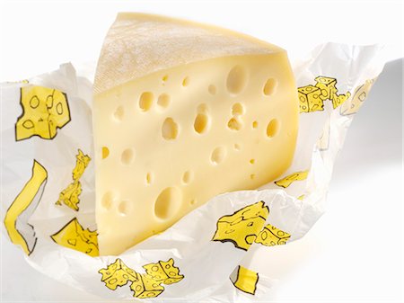 emmental - Piece of Emmental cheese in paper Foto de stock - Sin royalties Premium, Código: 659-03527475