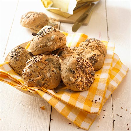 simsearch:659-03530672,k - Mixed seed bread rolls on a checked cloth Stock Photo - Premium Royalty-Free, Code: 659-03527777