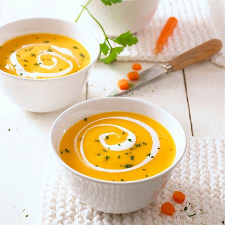 Two bowls of carrot soup with swirls of cream Stock Photo - Premium Royalty-Free, Code: 659-03527791