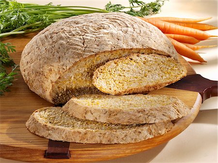 sesame bread - Carrot and sesame bread, partly sliced Stock Photo - Premium Royalty-Free, Code: 659-03527834