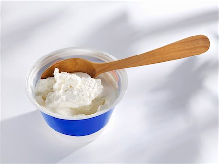 ricotta - Ricotta in plastic tub with wooden spoon Stock Photo - Premium Royalty-Free, Code: 659-03527836