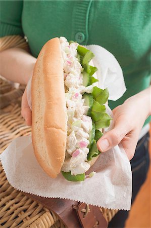 simsearch:659-03525975,k - Woman holding tuna sandwich and picnic basket Stock Photo - Premium Royalty-Free, Code: 659-03527870