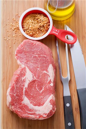 steak knife - Beef steak, spice mixture, cutlery and oil Stock Photo - Premium Royalty-Free, Code: 659-03528236