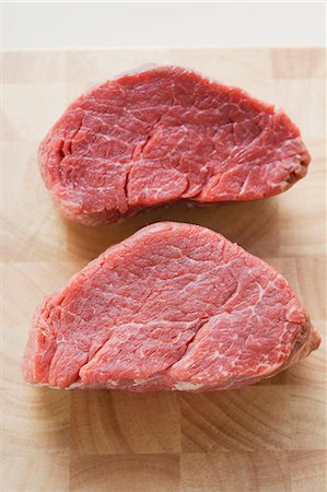 Two beef medallions on chopping board Stock Photo - Premium Royalty-Free, Code: 659-03528245