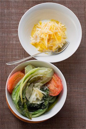 Yellow carrots with yoghurt, braised romaine lettuce with tomatoes Stock Photo - Premium Royalty-Free, Code: 659-03528269
