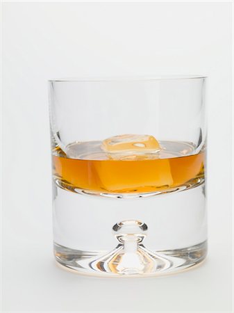 Glass of whisky with ice cube Stock Photo - Premium Royalty-Free, Code: 659-03528414