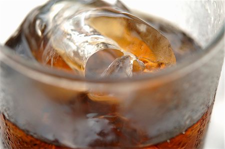 Glass of cola with ice cubes (close-up) Stock Photo - Premium Royalty-Free, Code: 659-03528468