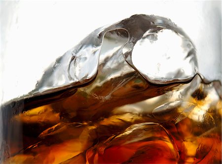 Glass of cola with ice cubes (close-up) Stock Photo - Premium Royalty-Free, Code: 659-03528469