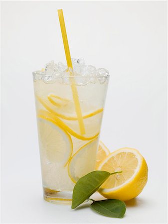 fruit drinks lemon - A glass of lemonade with crushed ice and straw Stock Photo - Premium Royalty-Free, Code: 659-03528501