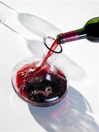 Pouring red wine into carafe Stock Photo - Premium Royalty-Free, Code: 659-03528744