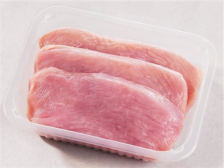 Three turkey escalopes in plastic container Stock Photo - Premium Royalty-Free, Code: 659-03528742