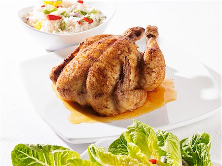 Whole roast chicken, vegetable rice and green salad Stock Photo - Premium Royalty-Free, Code: 659-03528759
