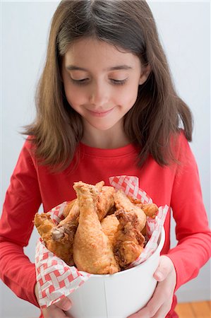 deep fried chicken - Little girl holding deep-fried chicken drumsticks Stock Photo - Premium Royalty-Free, Code: 659-03529051