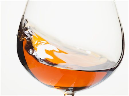 Cognac swirling in a glass Stock Photo - Premium Royalty-Free, Code: 659-03529189