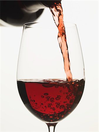 Pouring red wine into a glass Stock Photo - Premium Royalty-Free, Code: 659-03529194