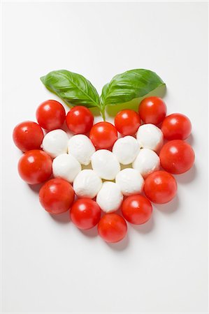 Tomato and mozzarella forming a heart with basil Stock Photo - Premium Royalty-Free, Code: 659-03529233