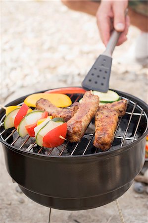 simsearch:659-08513112,k - Main en tournant les légumes sur le barbecue avec pinces à barbecue Photographie de stock - Premium Libres de Droits, Code: 659-03529494