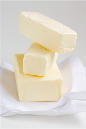 fat type - Blocks of butter, stacked, on paper Stock Photo - Premium Royalty-Free, Code: 659-03529558