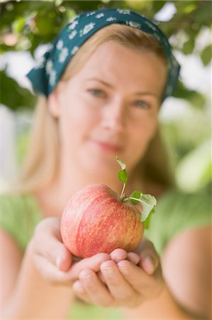 Woman holding an apple Stock Photo - Premium Royalty-Free, Code: 659-03529573